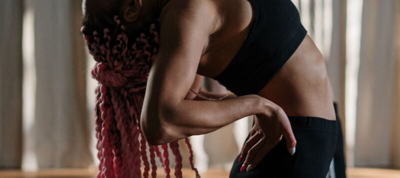Vrouw in een diepe zijwaartse buiging in een lichte yogastudio